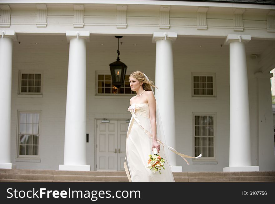 An image of a bride with hair and gown flowing in the breeze