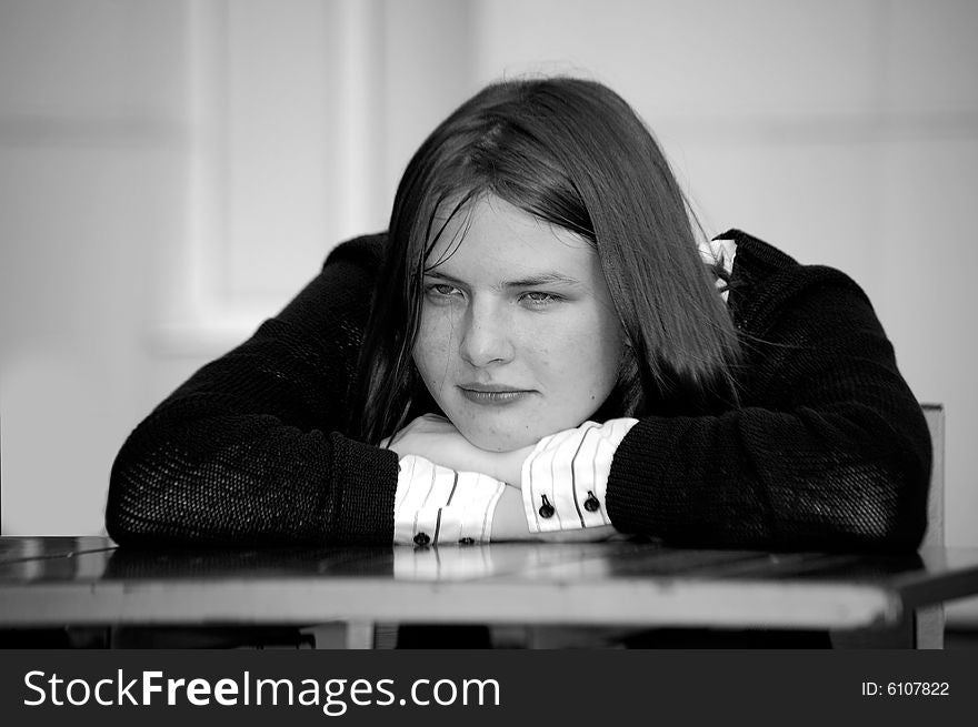 A black and white portrait of a girl that seems to be pensive. A black and white portrait of a girl that seems to be pensive