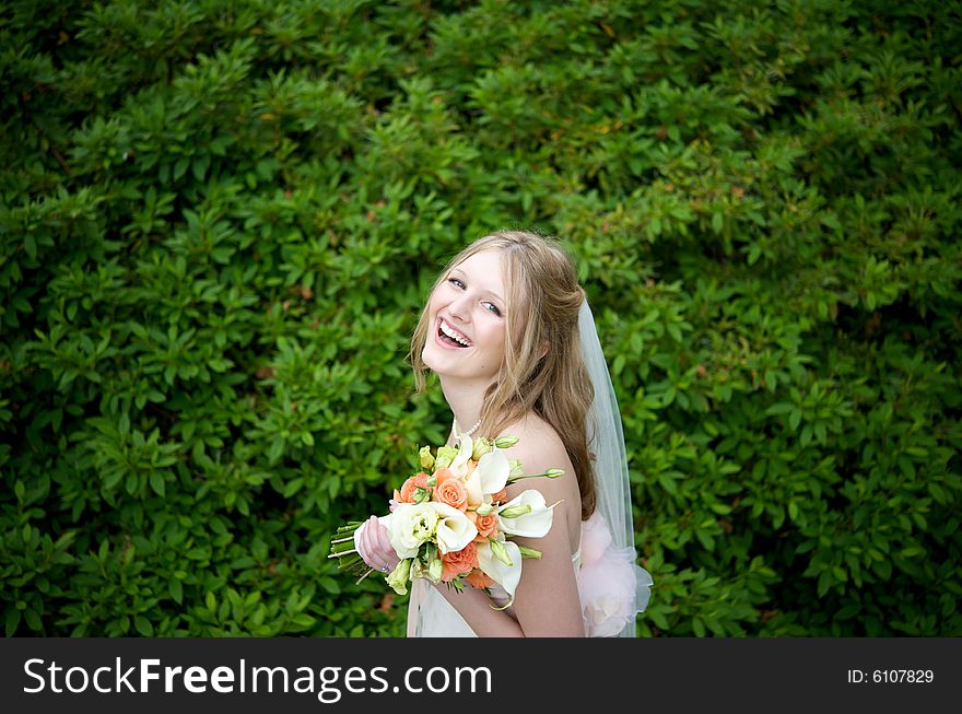 Laughing Bride Against Lush Foliage