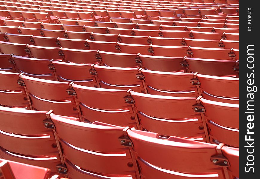 Backs of red stadium chairs at millenium park in Chicago