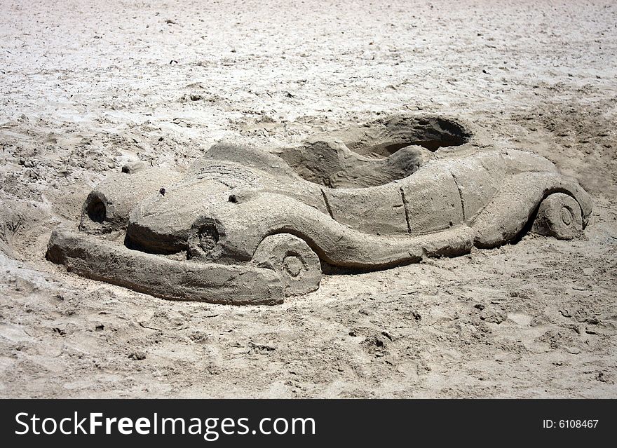 Car made from sand on a beach. Car made from sand on a beach.