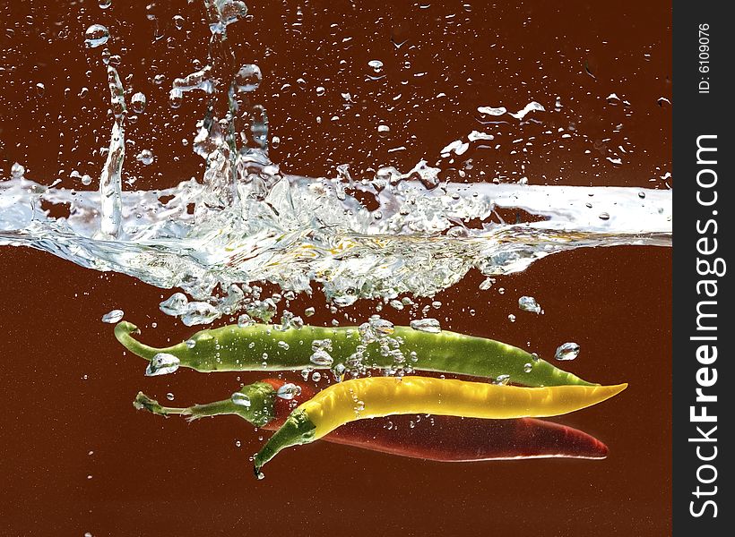 Chili peppers in water with splash