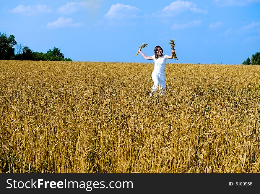 Happy young girl running on the field. Smiling face. Happy young girl running on the field. Smiling face.