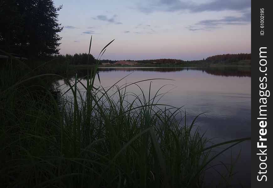 The late evening sunset over the lake in the summer