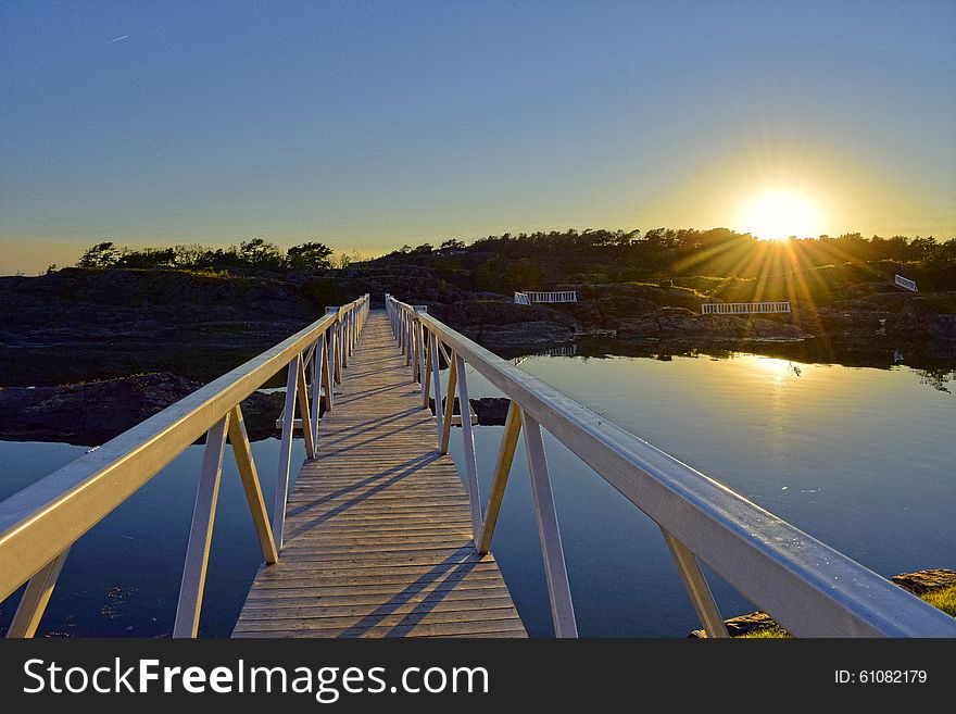 A white bridge illuminated by the sun-rays. This bridge is located at Krogshavn in Norway. A white bridge illuminated by the sun-rays. This bridge is located at Krogshavn in Norway