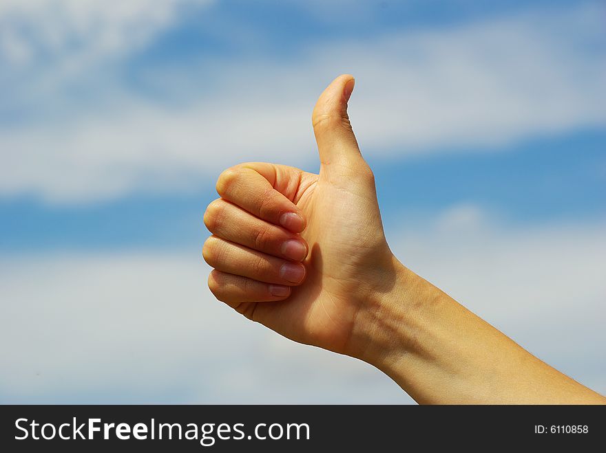 Womans hand with thumb up ok signal