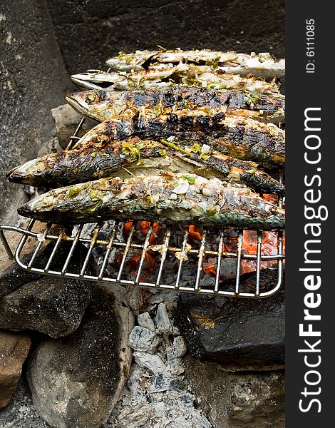 Grilled fishes laying on hot grill. Grilled fishes laying on hot grill