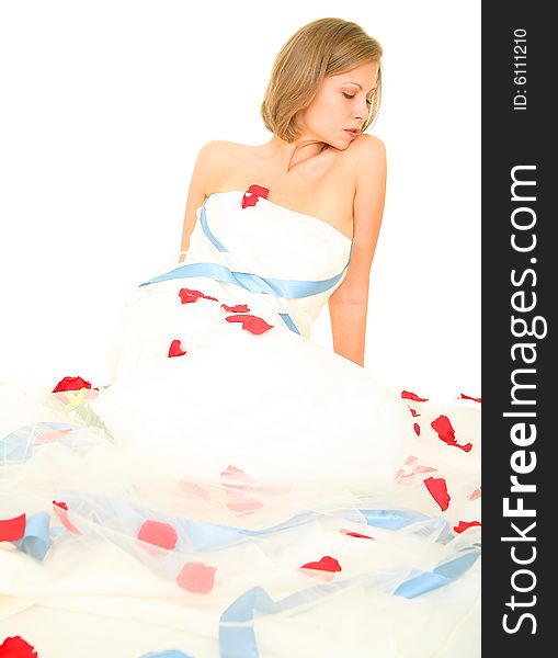 Bride in her gown sitting on the floor with rose petal around her. Bride in her gown sitting on the floor with rose petal around her