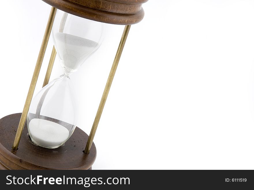 Old style hourglass with white sand on a white background