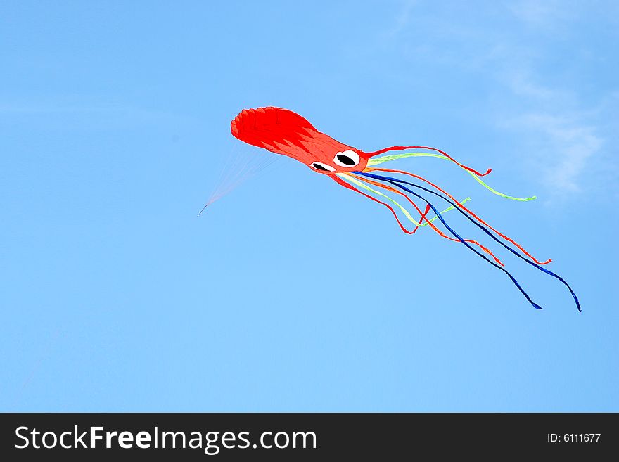 A colourful cuttlefish kite on a blue sky