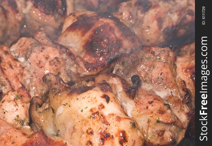 Shish kebab preparation on a brazier. Outdoor picnic. Close up.