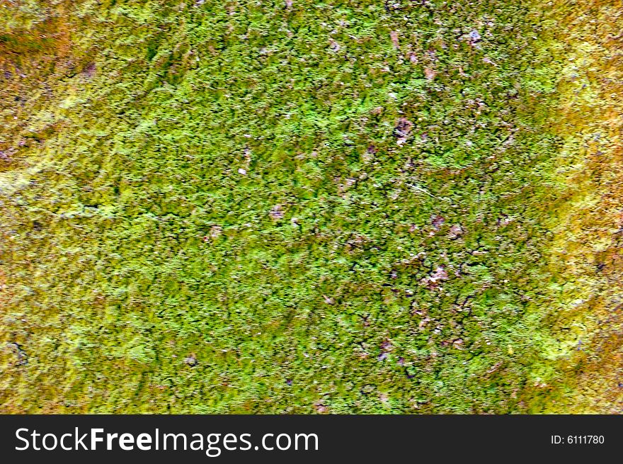 Colored (prevaling green and yellow) rough stone surface with lichen