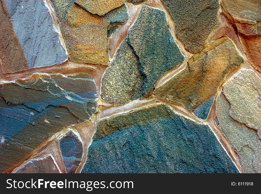 Colored rough wall surface made of wild stones. Colored rough wall surface made of wild stones