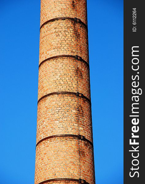 Old brick tower detail and clear blue sky. Old brick tower detail and clear blue sky