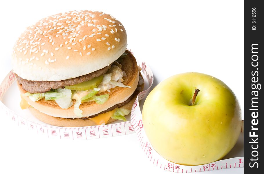 Hamburger, apple and measuring tape isolated on a white background.