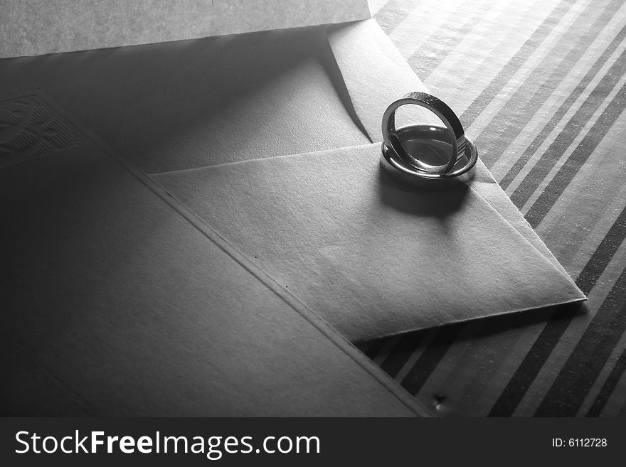 Two wedding rings on an envelope