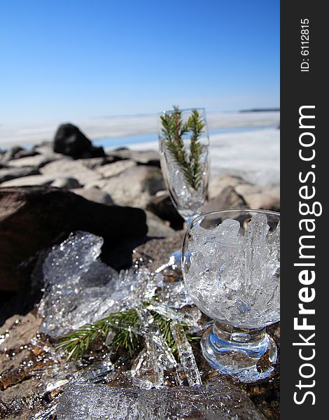 Glasses with ice on the edge of a frozen lake