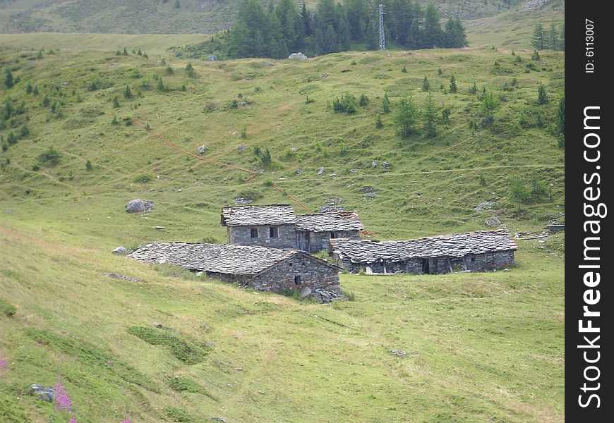 Old mountain farms and houses along a trekking road in Pila, Valle d'Aosta, Italy, Europe. Old mountain farms and houses along a trekking road in Pila, Valle d'Aosta, Italy, Europe