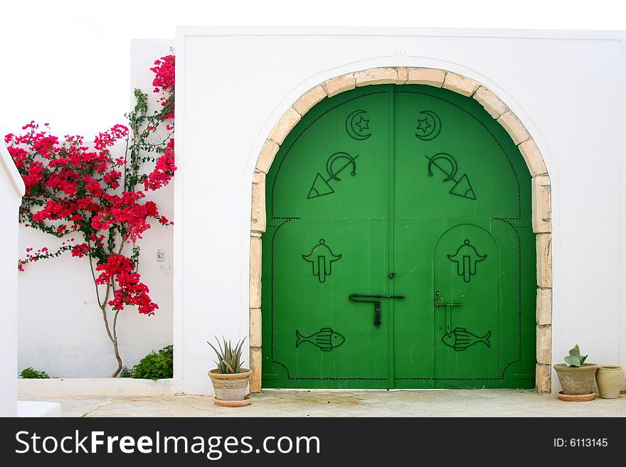 Green gate with arabic symbols.