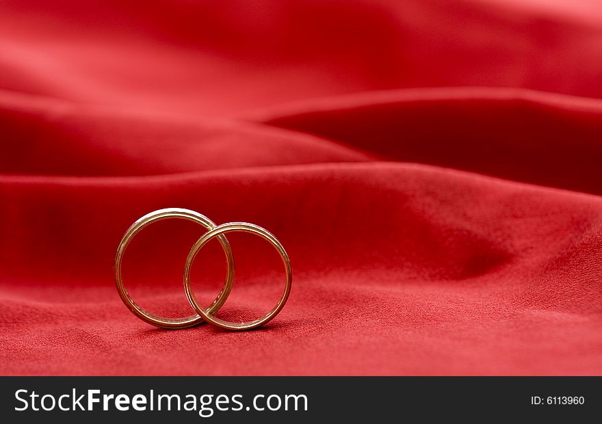Wedding rings on a red background
