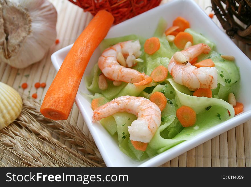 A salad of cucumbers, carrots and prawns
