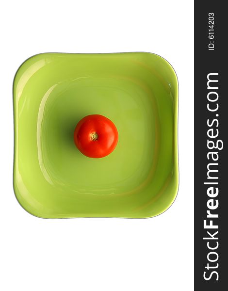 Red tomato in green dish.