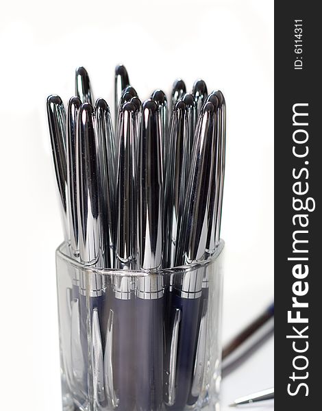 Glass glass with beautiful metallic pens. Glass glass with beautiful metallic pens