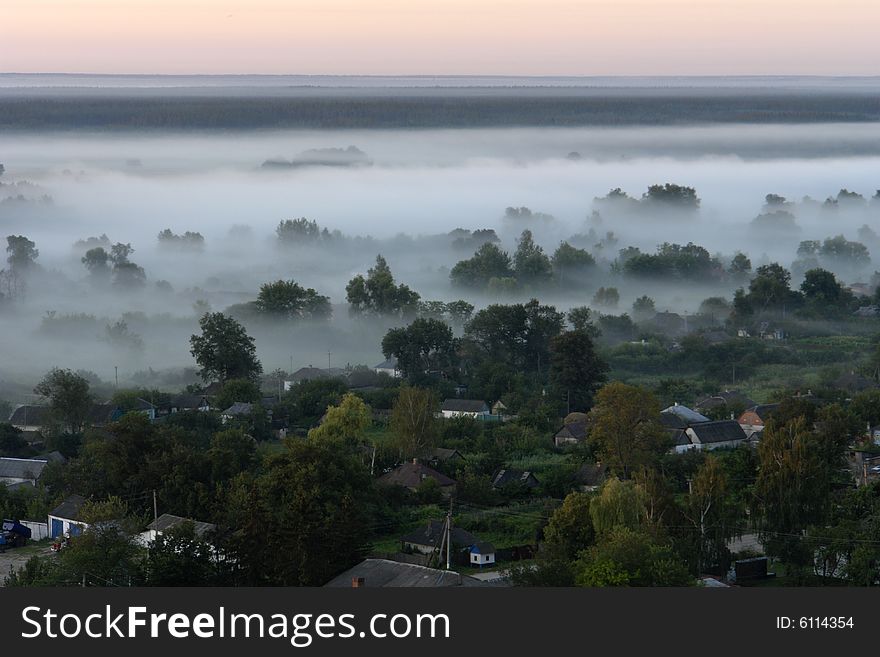 Village on a background of a fog