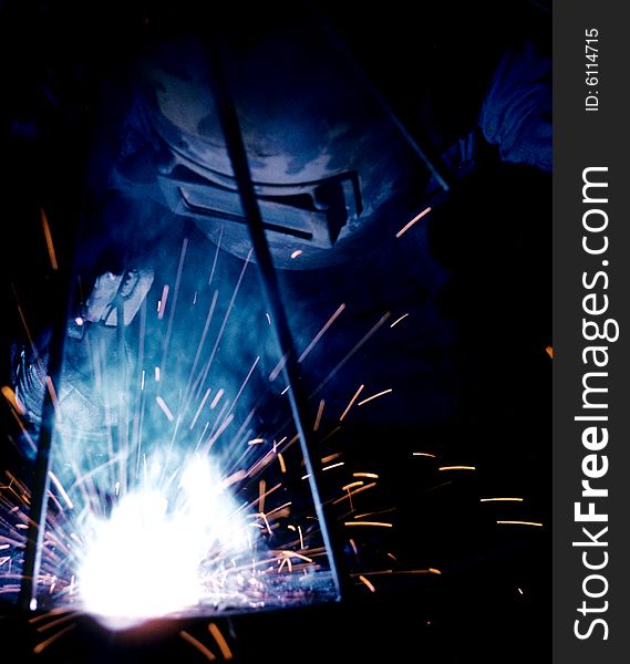 A steel worker manufacturing metal work. A steel worker manufacturing metal work