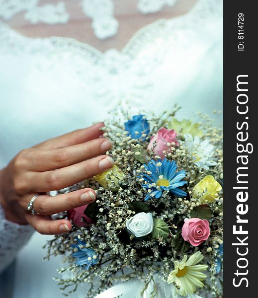 A bride holds her bouquet. A bride holds her bouquet