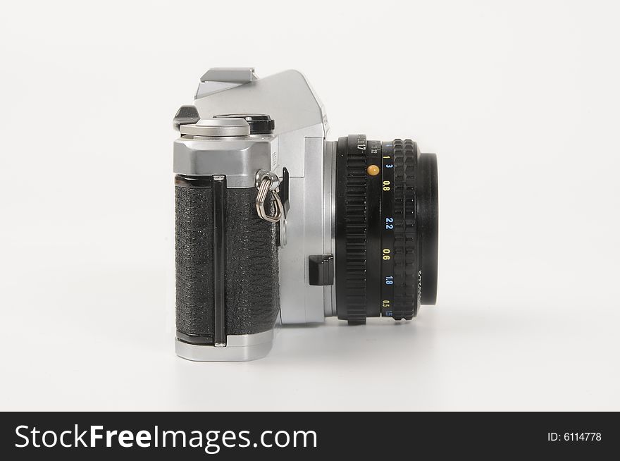 A classic manual camera with 50mm lens mounted, isolated on white.