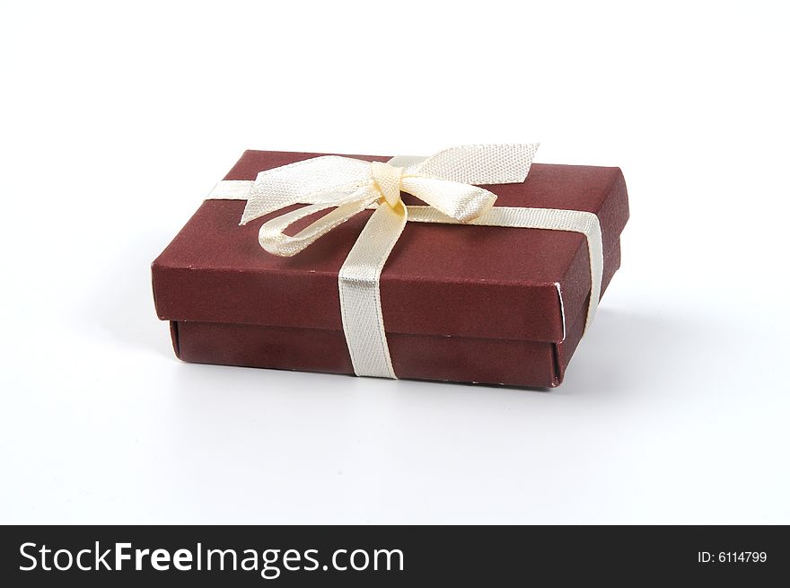 Brown giftbox with loops on white background.