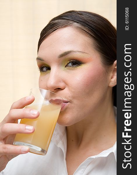 Attractive brunette woman drinking orange juice. Attractive brunette woman drinking orange juice