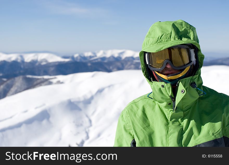 The snowboarder on a background of the blue sky