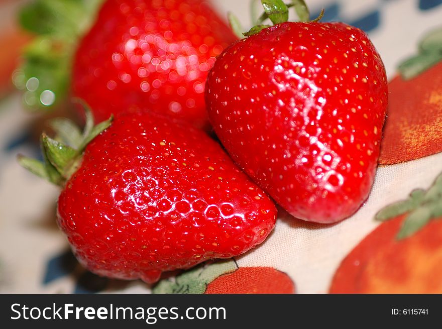 Red strawberries against floreal background. Red strawberries against floreal background