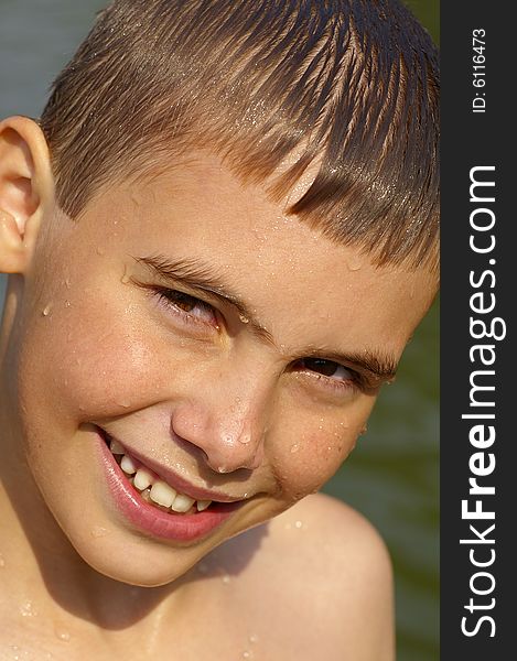 Face of the boy of ten years after bathing in the lake