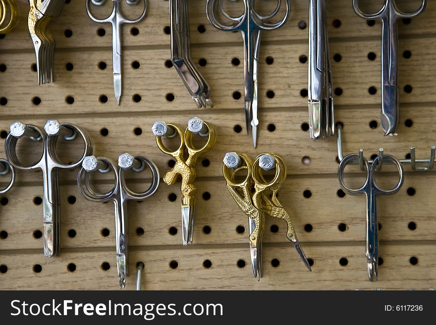 A display of fancy scissors and sewing tools.