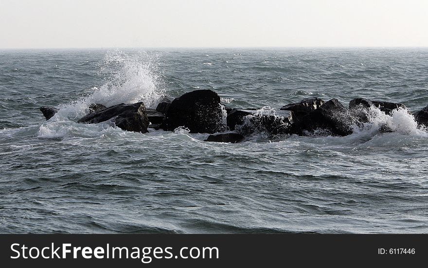 Waves breaking over rocks in the ocean. Waves breaking over rocks in the ocean