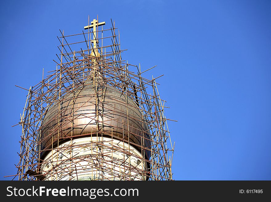 Restoration site of an orthodox church â€“ scaffoldings around church cupola