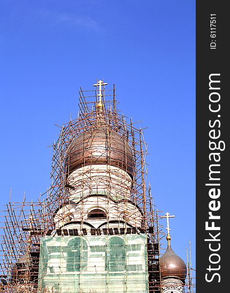 Restoration site of an orthodox church â€“ scaffoldings around church cupola