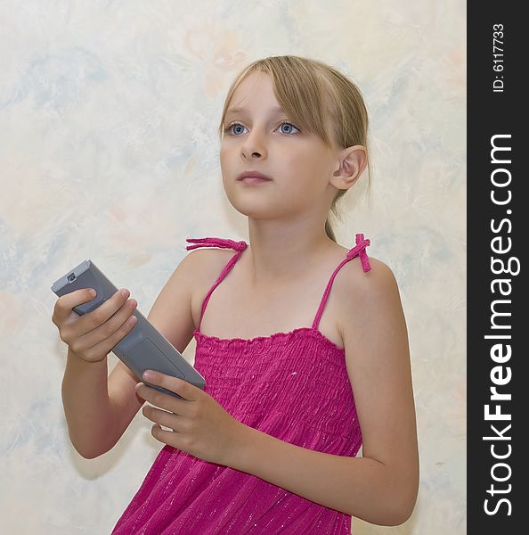 Little girl pushing button on remote control