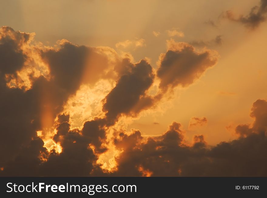 Sunset in clouds with rays of light