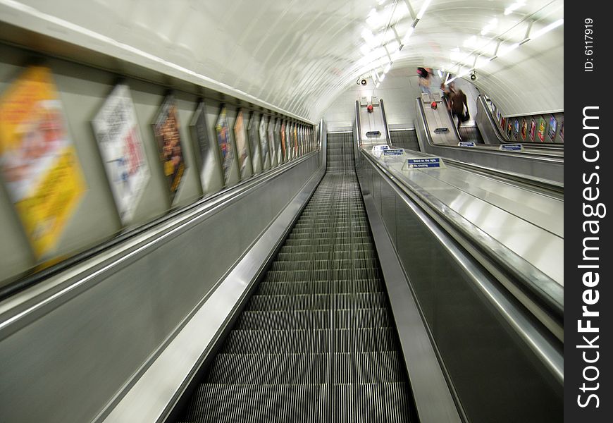 Going down in steel escalator at london subway. Going down in steel escalator at london subway