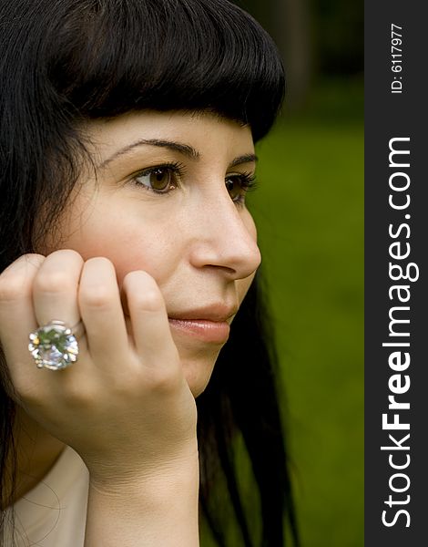 Closeup portrait of young brunette in the park