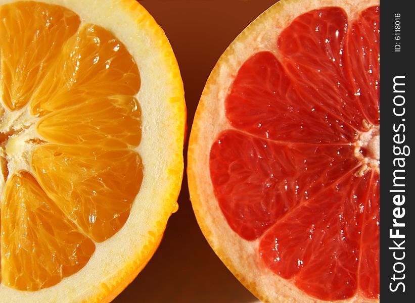 Halved orange and red grapefruit. Halved orange and red grapefruit.