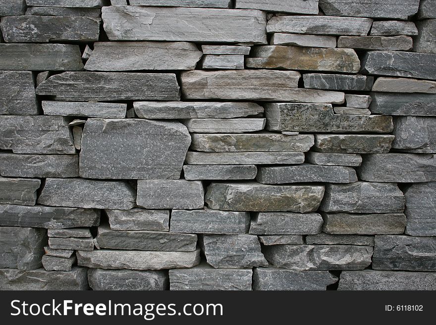 Traditional way of building stone walls in Ireland, crushed flat stones from a rock, on flat, mortar hidden at the back. Traditional way of building stone walls in Ireland, crushed flat stones from a rock, on flat, mortar hidden at the back