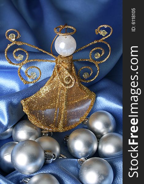 Golden Christmas tree angel amongst silver decorations. Golden Christmas tree angel amongst silver decorations
