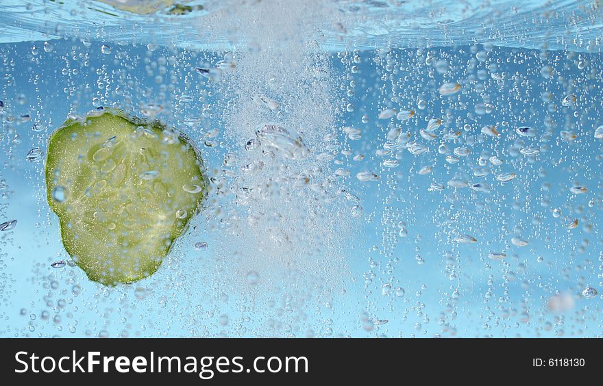 Cucumber slice splashing in the water