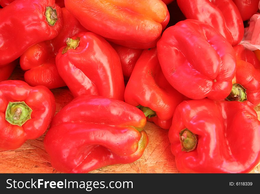 Bright red peppers at a produce market.