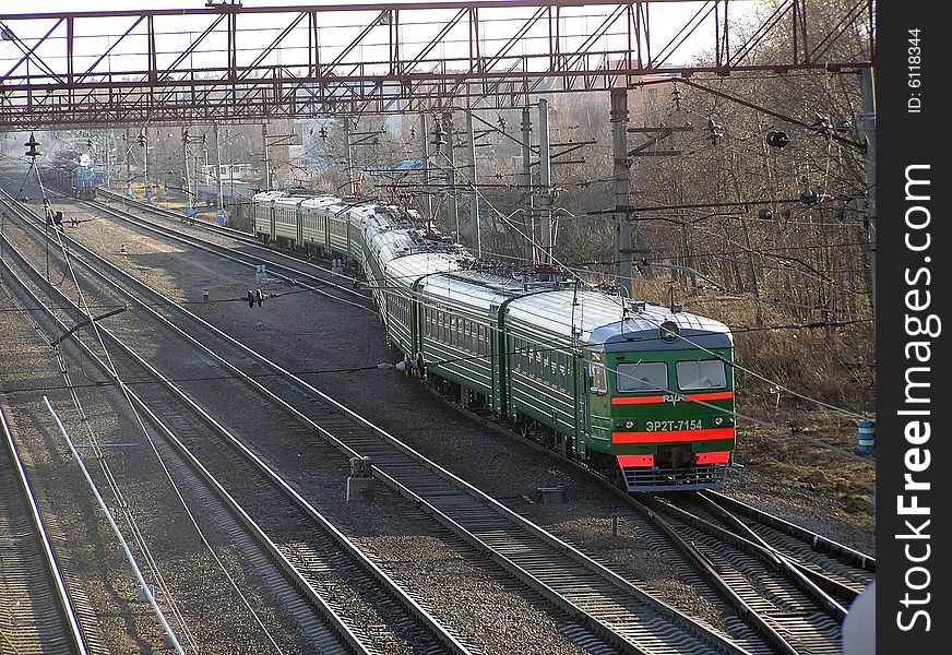 The twisting electric train which is driving off from station